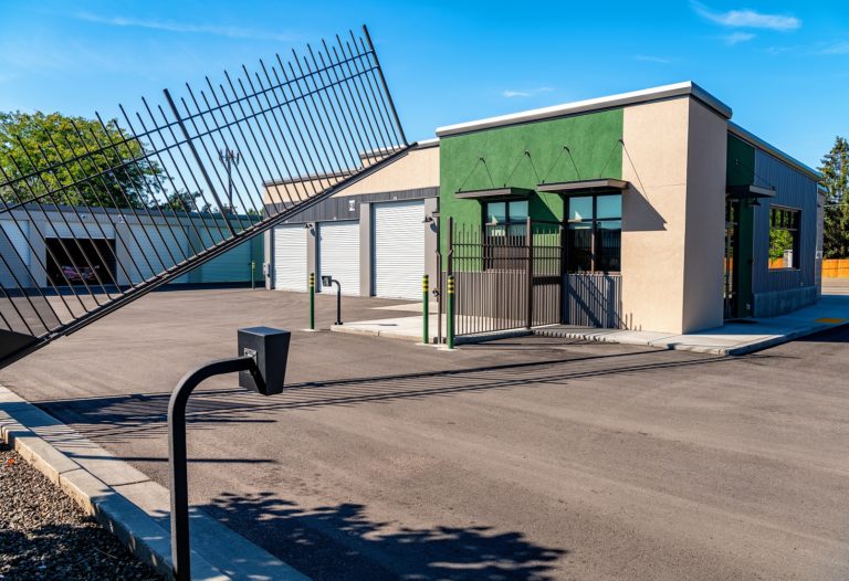 Metal gate opens to let traffic in at a mini storage place